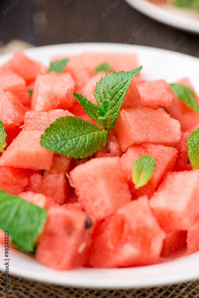 watermelon slices cut on the plate with mint watermelon slices cut on the plate with mint