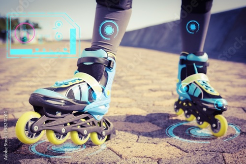 Obraz na plátně Close up view of woman wearing inline skates against fitness interface