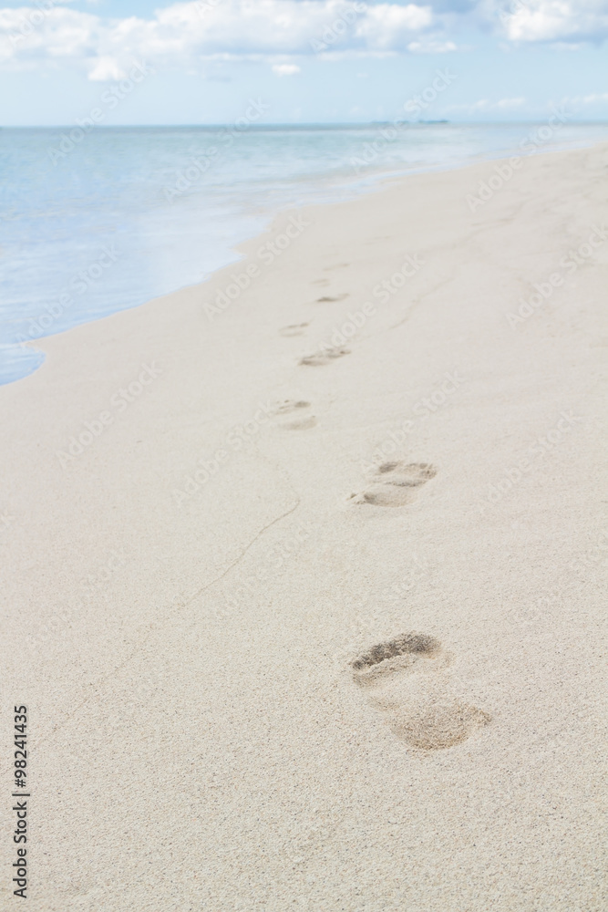 Foot prints on a sandy beach with selective focus Foot prints on a sandy beach with selective focus