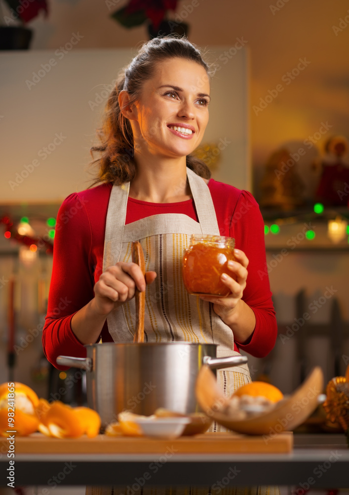 housewife making homemade orange marmalade in Christmas kitchen