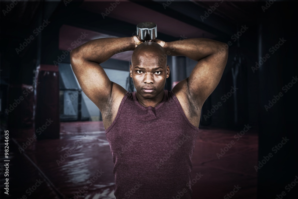 Composite image of fit man exercising with dumbbell Composite image of fit man exercising with dumbbell