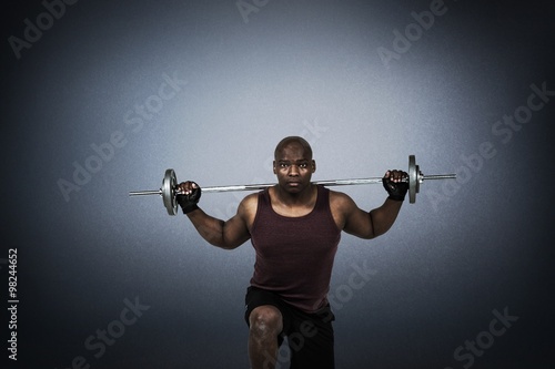 Composite image of fit man exercising with barbell 