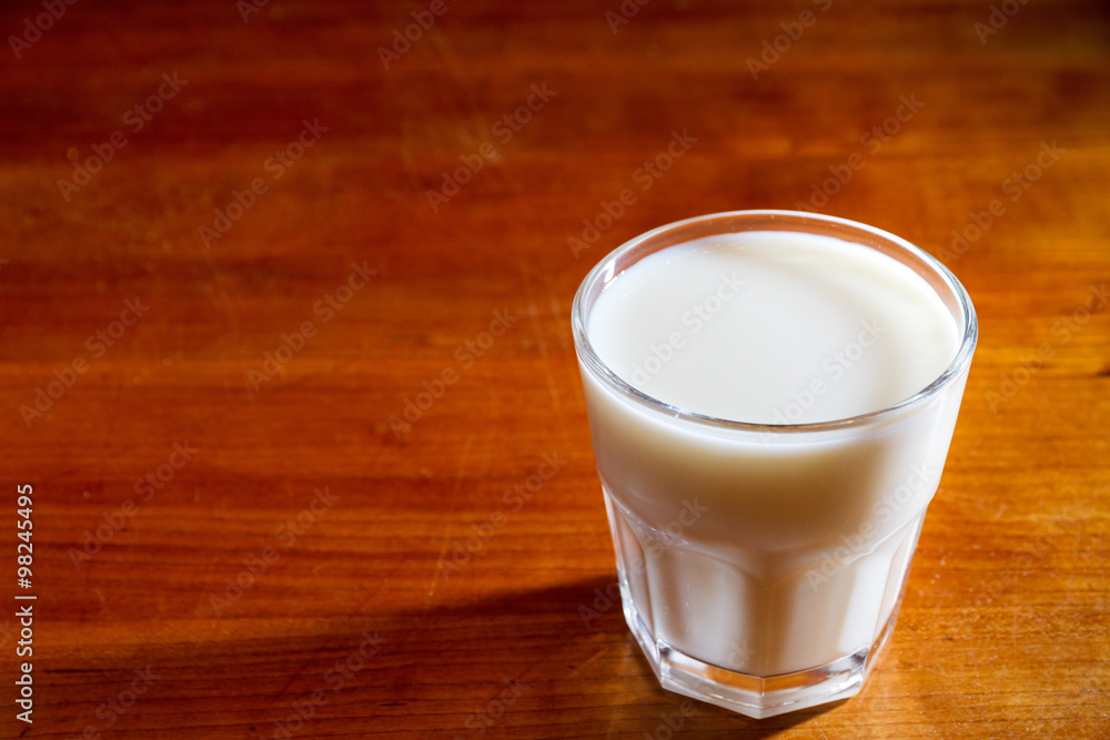 Glass of milk on a wooden table Glass of milk on a wooden table