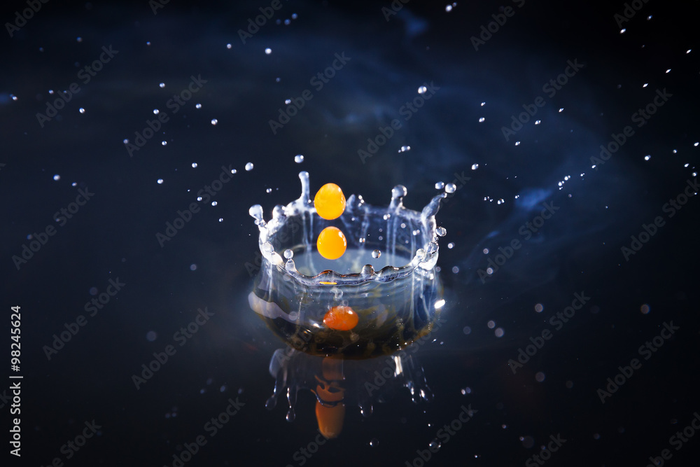 Drops of milk with coffee splashing in water, high speed Drops of milk with coffee splashing in water, high speed