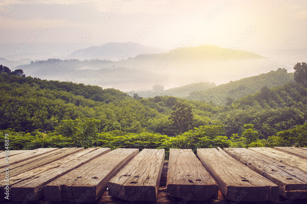wooden table and view of mountain with sun light wooden table and view of mountain with sun light