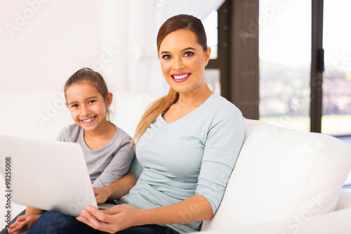 young woman and daughter with laptop © michaeljung