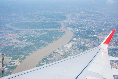 Town and river as seen through window of an aircraft