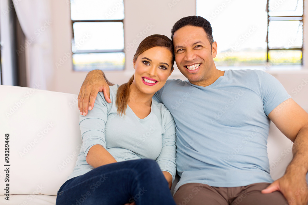 couple sitting on sofa at home couple sitting on sofa at home