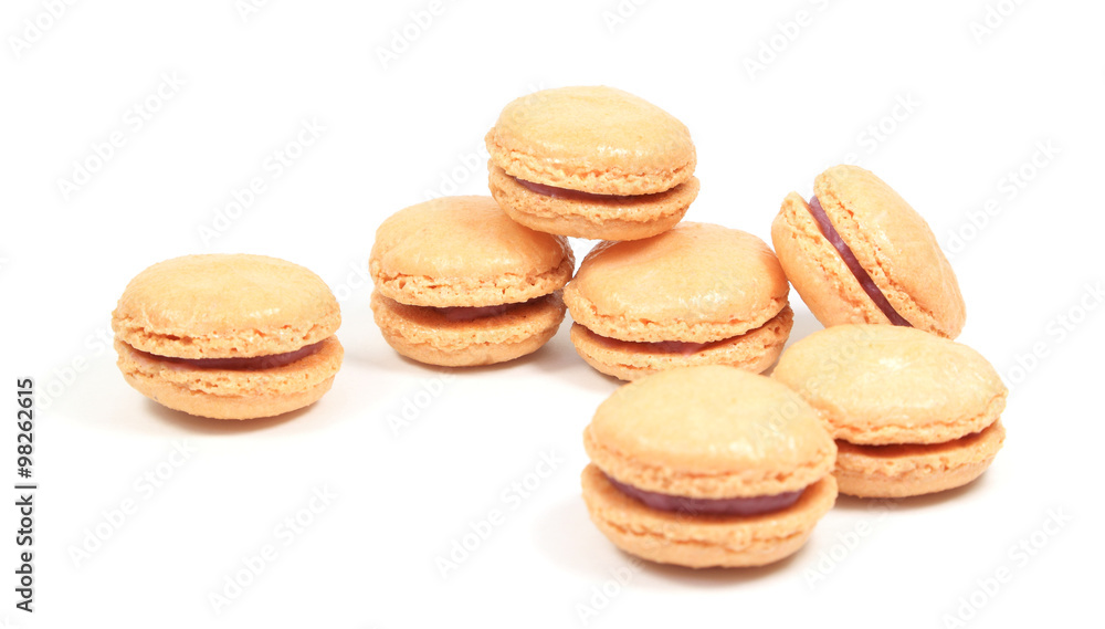 French macarons stuffed with raspberry filling on a white background.