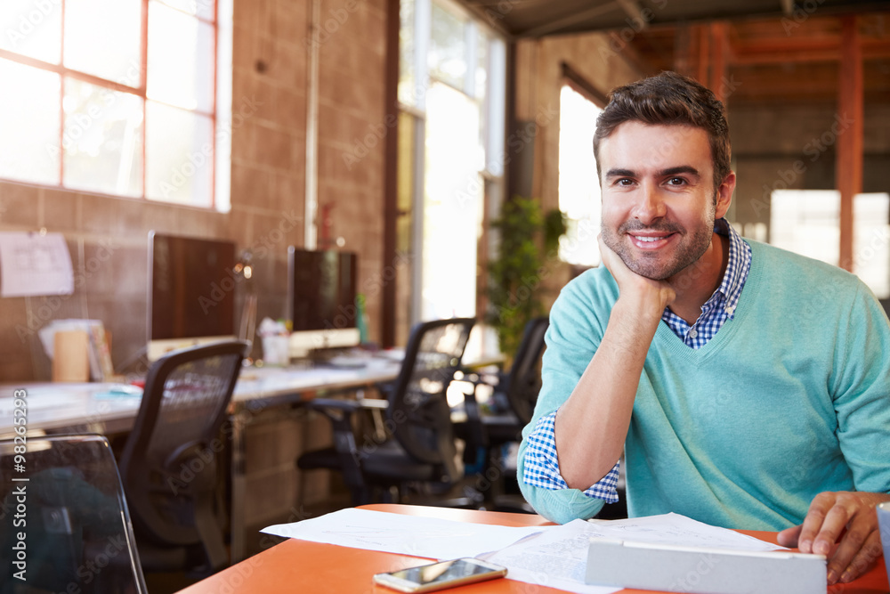 Designer Sitting At Meeting Table Working On Digital Tablet Designer Sitting At Meeting Table Working On Digital Tablet