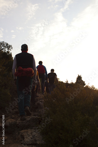 group of mountaineers hiking in in a sunset