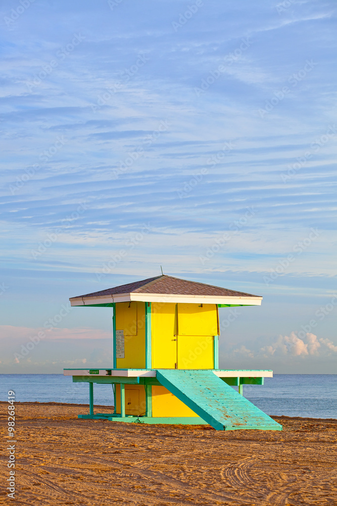 Hollywood Beach Florida, bright yellow lifeguard house at sunrise with ocean and beautiful sky in the background Hollywood Beach Florida, bright yellow lifeguard house at sunrise with ocean and beautiful sky in the background