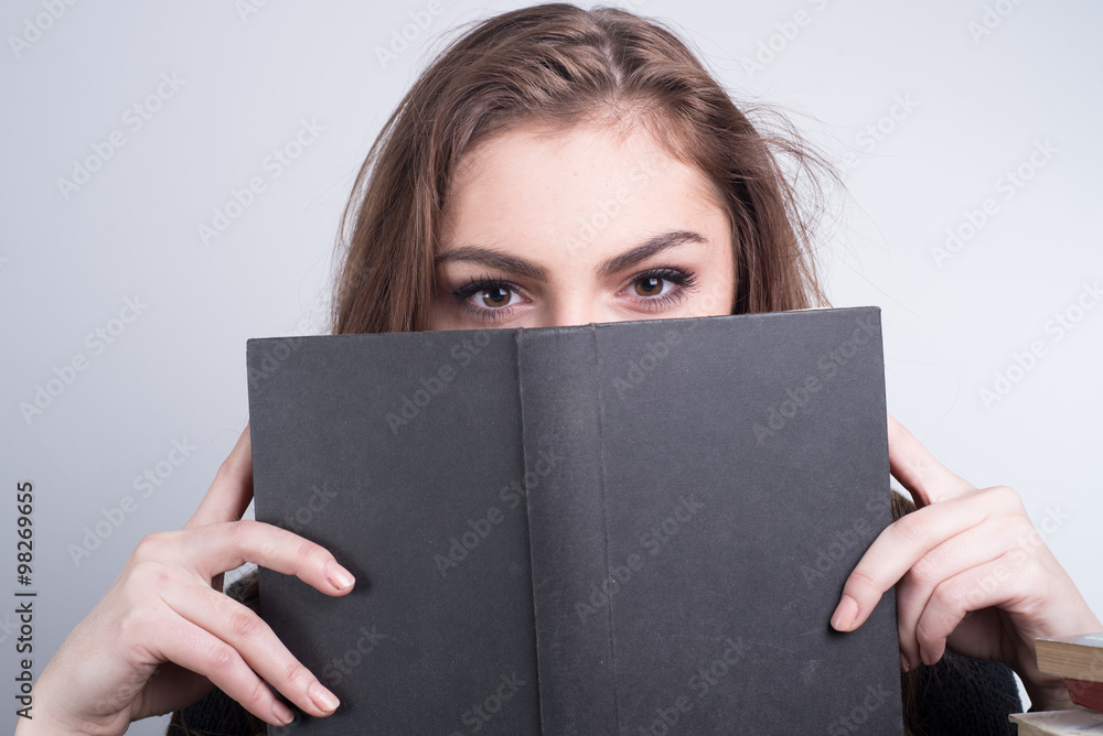 book worm ,girl looking over the book book worm ,girl looking over the book