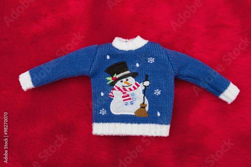 White and Blue Snowman Christmas Sweater on Red Plush Fur