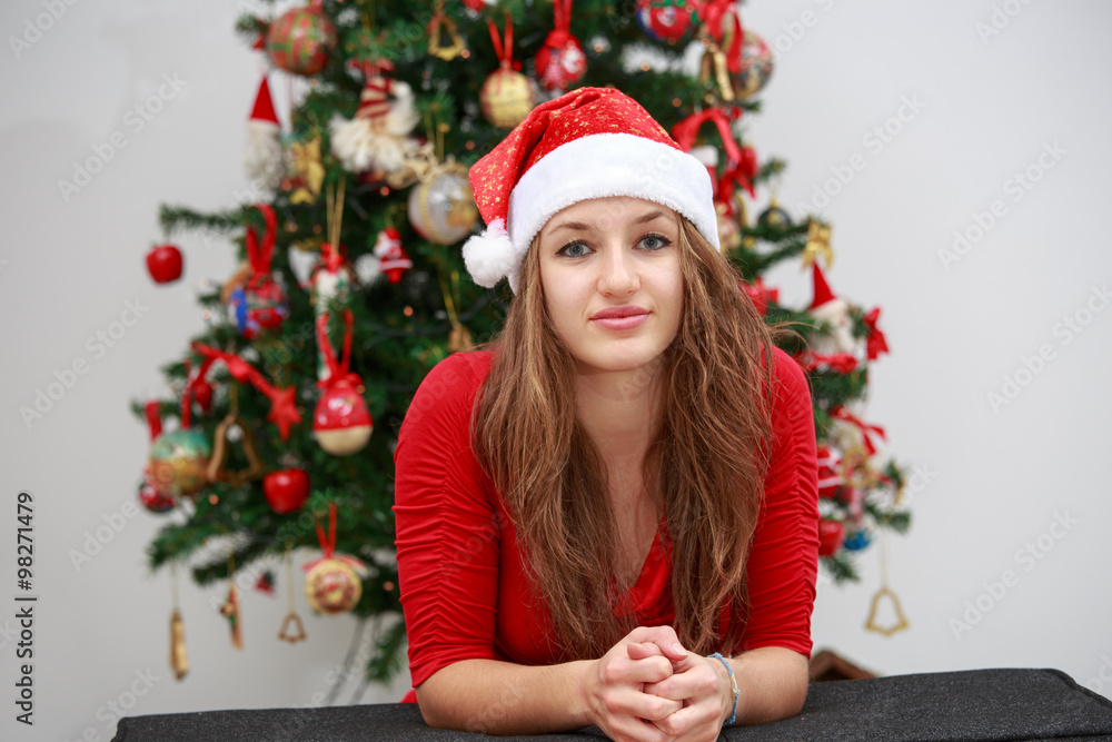 Beautiful girl in front of a Christmas tree