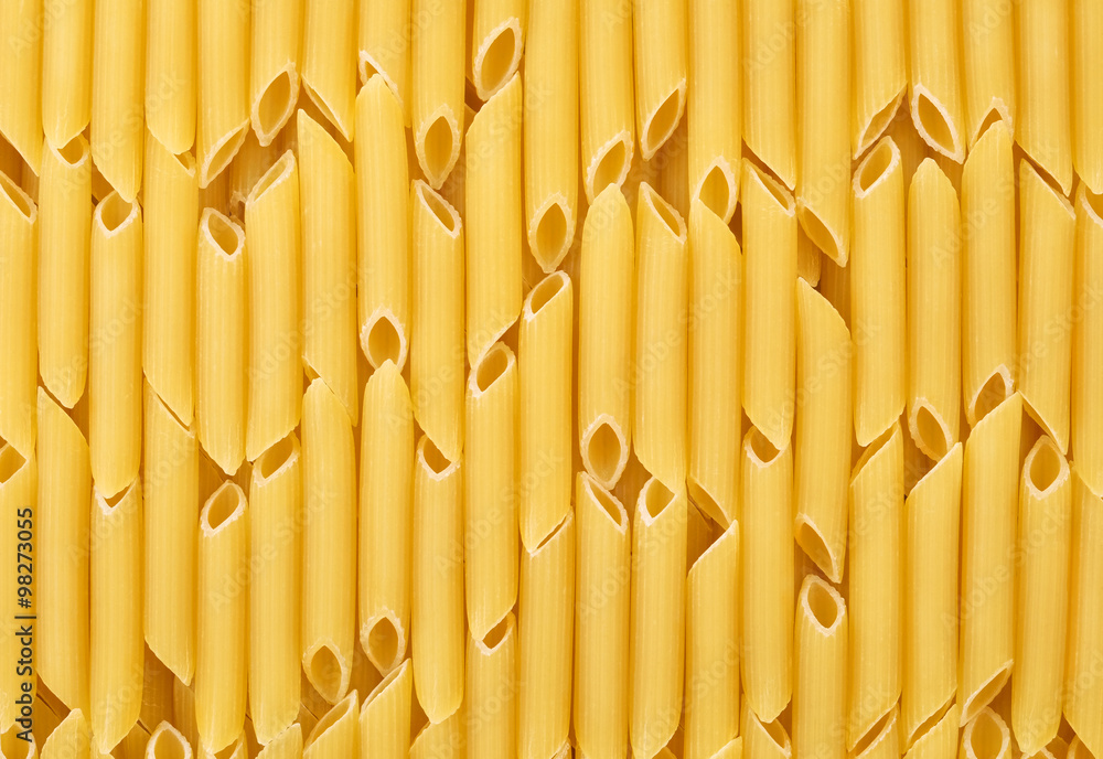 Italian uncooked pasta penne sorted vertically for background or texture. - obrazy, fototapety, plakaty 