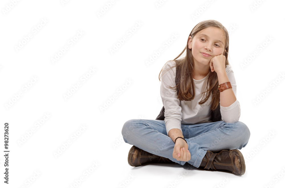young teenager sitting cross-legged on the floor on white young teenager sitting cross-legged on the floor on white