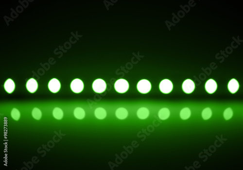 Foto Play of green light on defocusing blur led lamps background