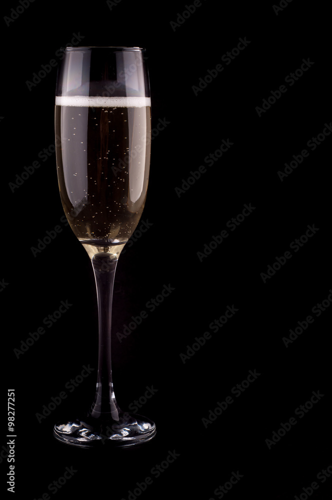 A glass of champagne on black background A glass of champagne on black background