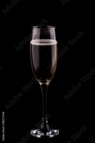 A glass of champagne on black background