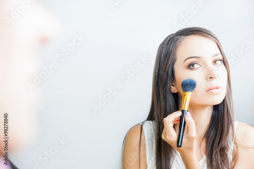 makeup artist woman doing make-up using cosmetic brush for yourself