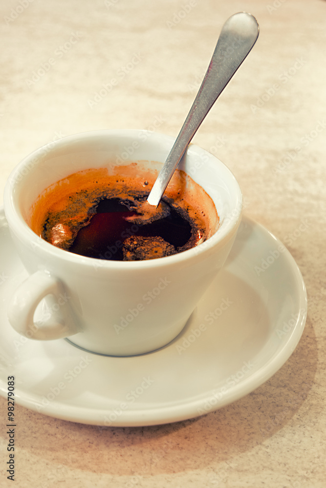 Coffee with spoon inside, side view Coffee with spoon inside, side view