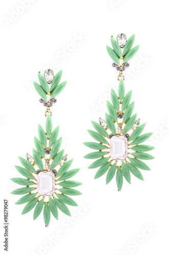 Green earrings inlaid with precious stones on a white background
