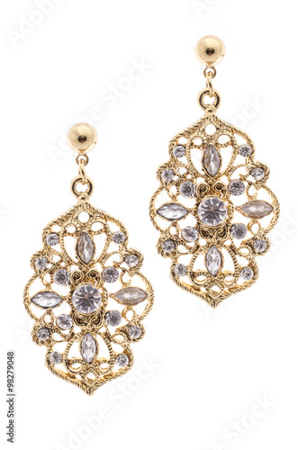 Gold earrings inlaid with precious stones on a white background