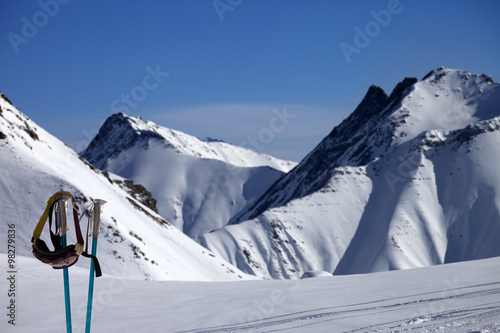 Ski mask on ski poles and off-piste slope