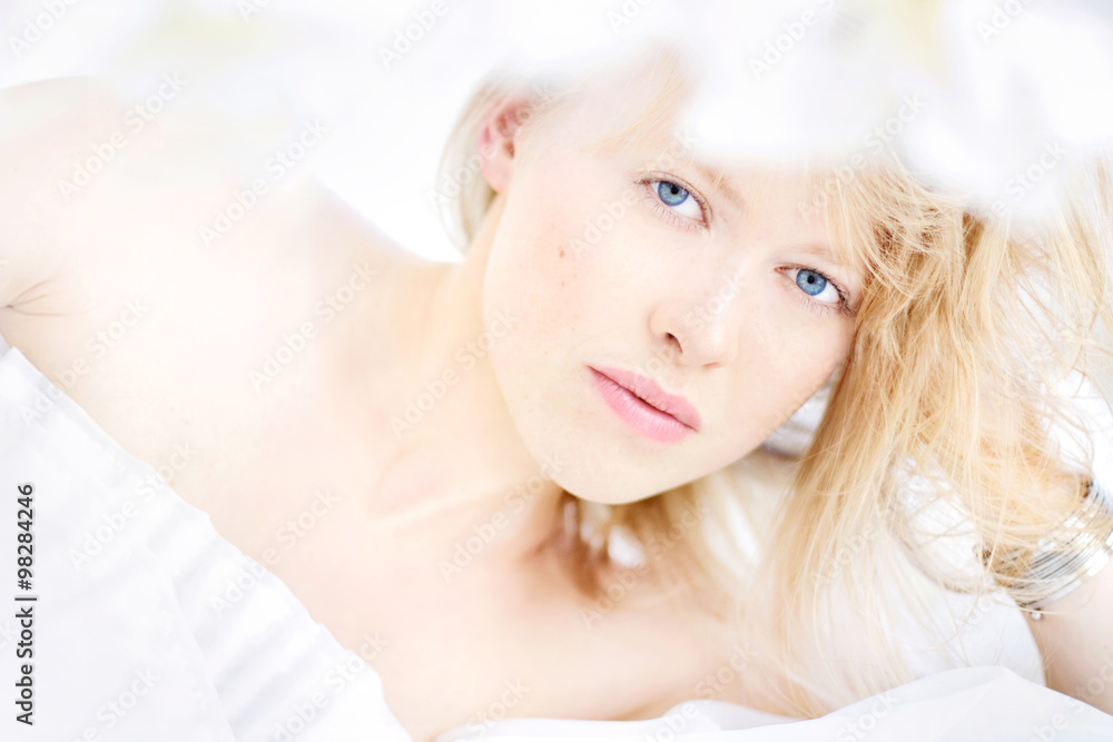 Beautiful attractive young woman (close up face) in white dress with caucasian healthy skin, blond hair, blue eyes and glamour lips. Model appearance, fashion look Beautiful attractive young woman (close up face) in white dress with caucasian healthy skin, blond hair, blue eyes and glamour lips. Model appearance, fashion look