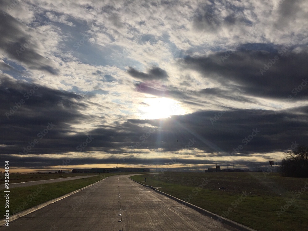 road with clouds and sun light road with clouds and sun light