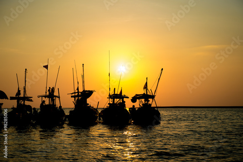 Silhouette local boat with sunset at pangnga provience, Thailand photo