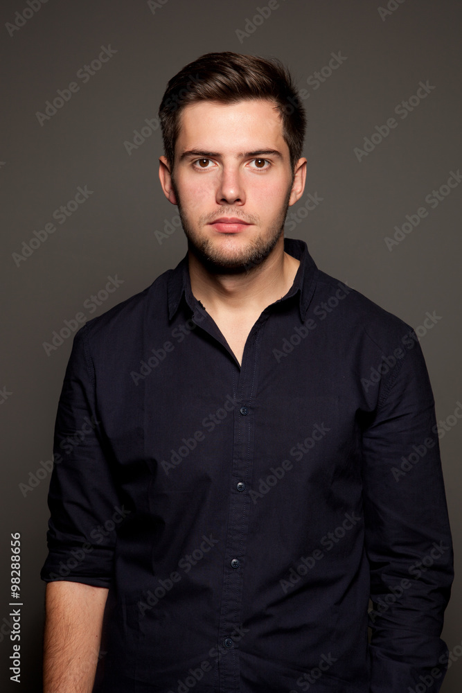 portrait of a young man on a gray background