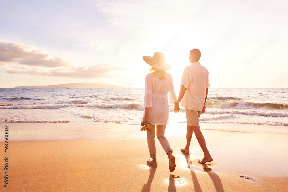 Mature Couple Walking on the Beach at Sunset