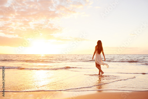 Happy Carefree Woman on the Beach at Sunset