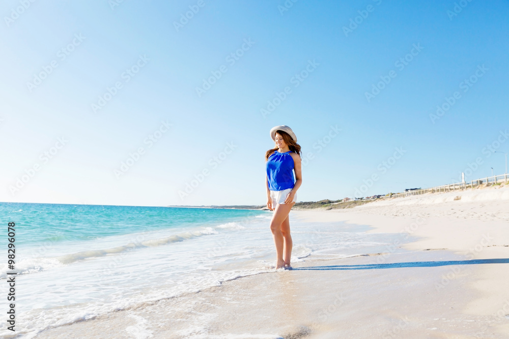 Young woman walking along the beach