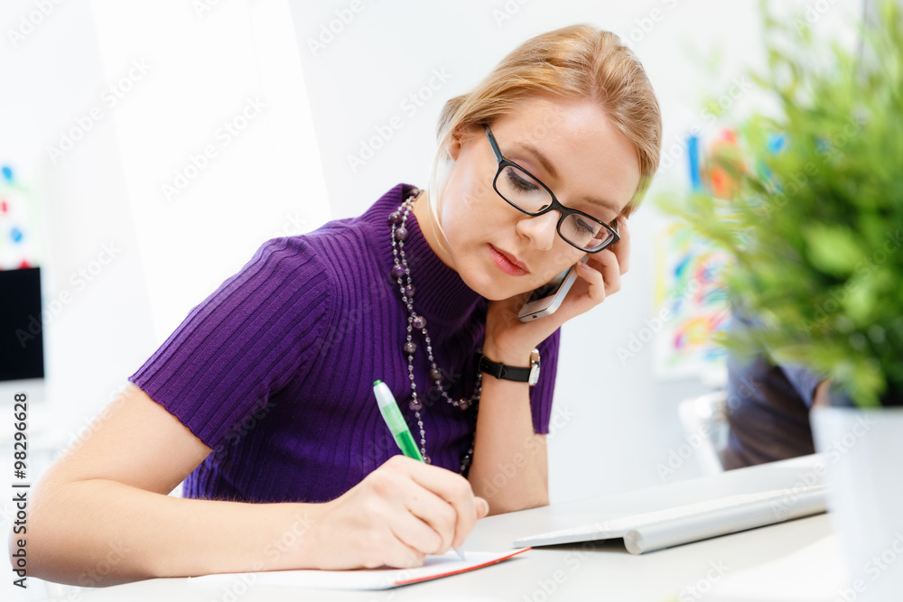 Business woman in office holding mobile phone Business woman in office holding mobile phone