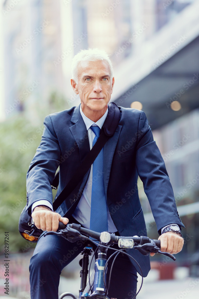 Fototapeta premium Successful businessman riding bicycle