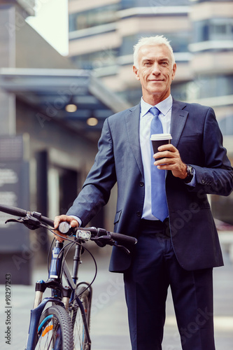 Successful businessman riding bicycle