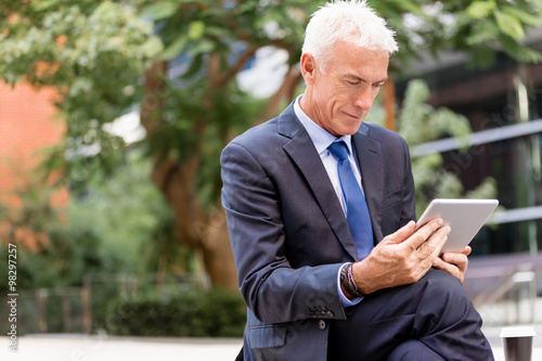 Senior businessman holding touchpad 