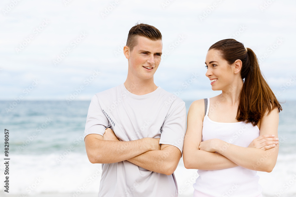 Fototapeta premium Young couple looking at each other on beach
