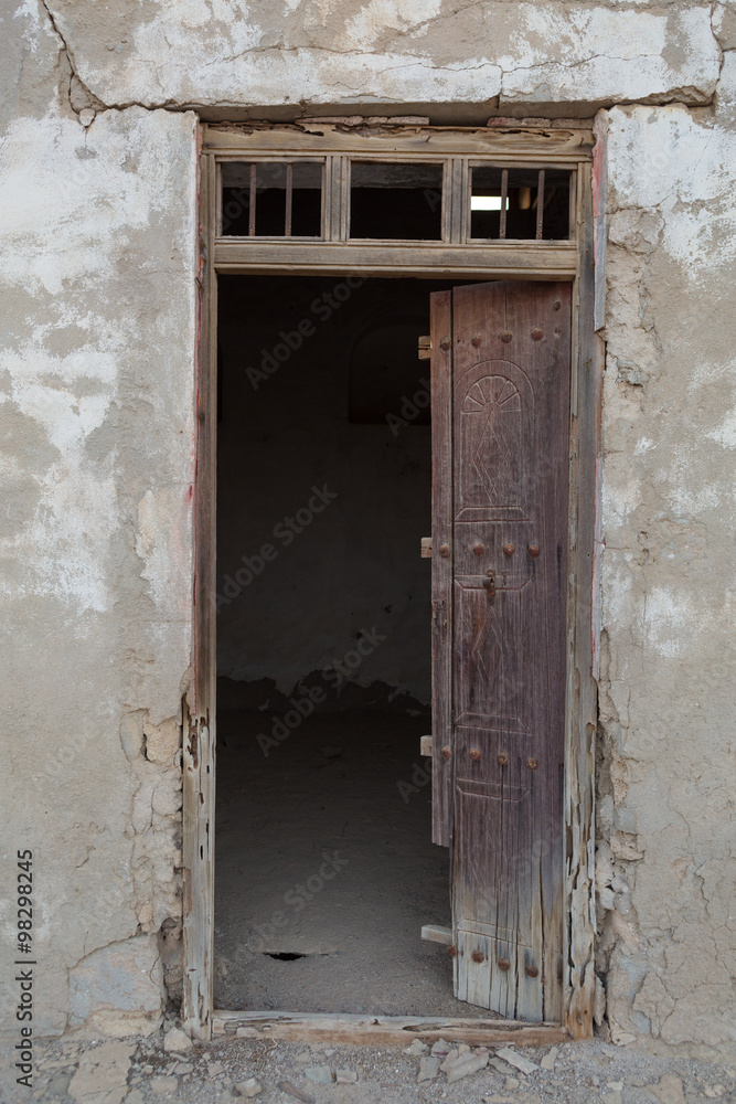 Traditional weathered wooden door frame, Old Ras Al Khaimah abandoned ghost town, Al Jazirah Al Hamra
