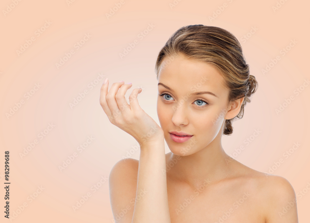 woman smelling perfume from wrist of her hand woman smelling perfume from wrist of her hand