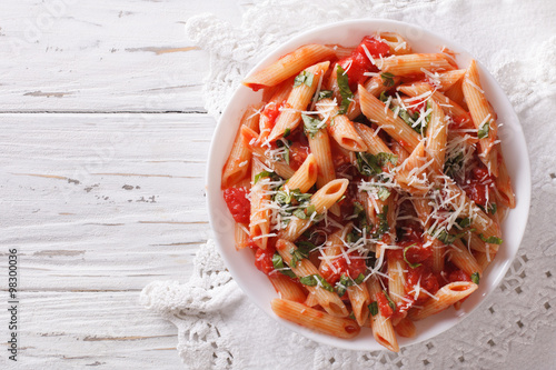 Arrabiata pasta penne with Parmesan cheese. Horizontal top view
 photo