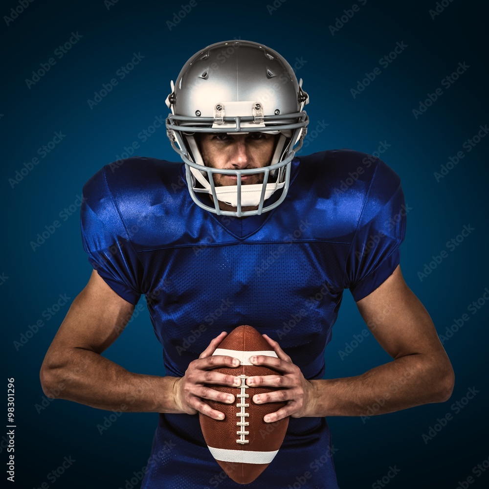 American football player holding ball American football player holding ball