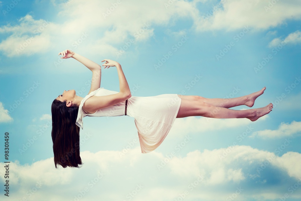 Composite image of girl in white dress floating in air Composite image of girl in white dress floating in air