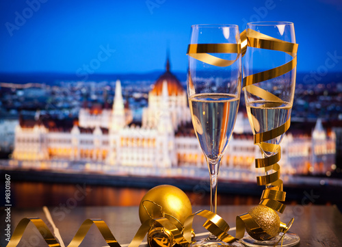 New Year in Budapest - Champagne glasses and Budapest parliament with fireworks in the background