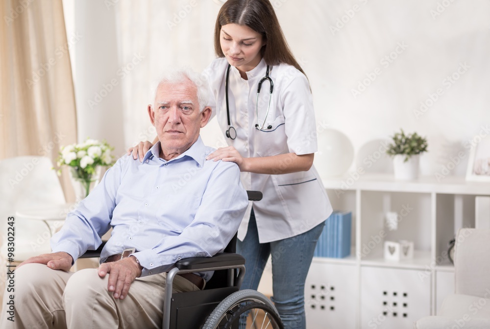 Fototapeta premium Nurse with old man on wheelchair