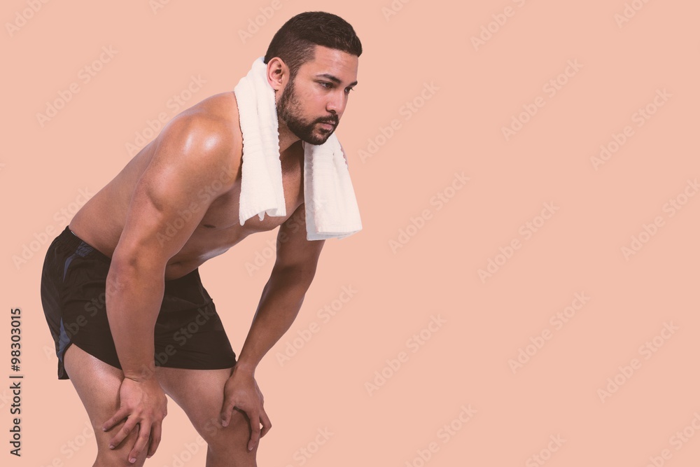 Composite image of muscular man with towel on shoulders