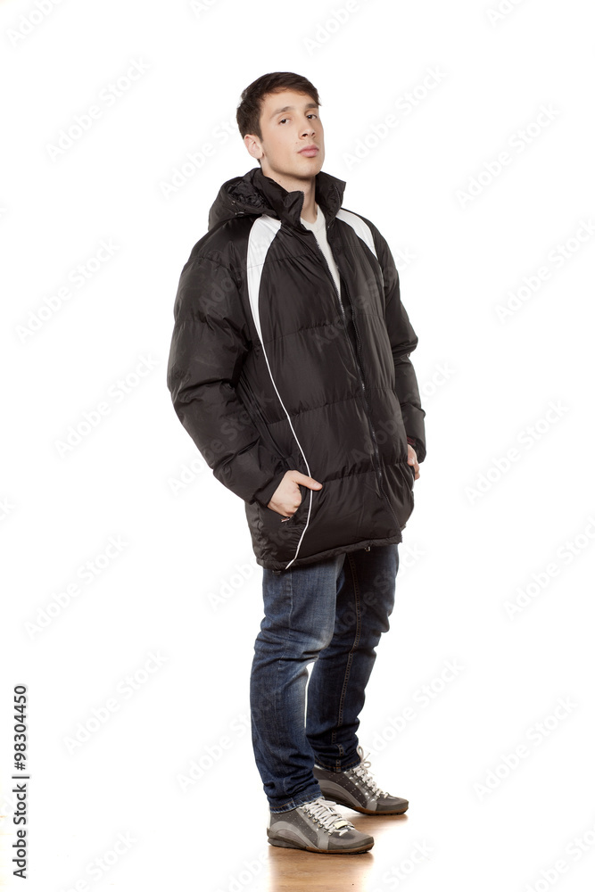 young handsome man posing with winter jacket young handsome man posing with winter jacket